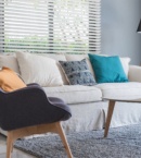 White venetian blinds in modern scandi lounge room on blue grey walls