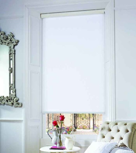 white blockout roller blinds in traditional victorian lounge room on white walls