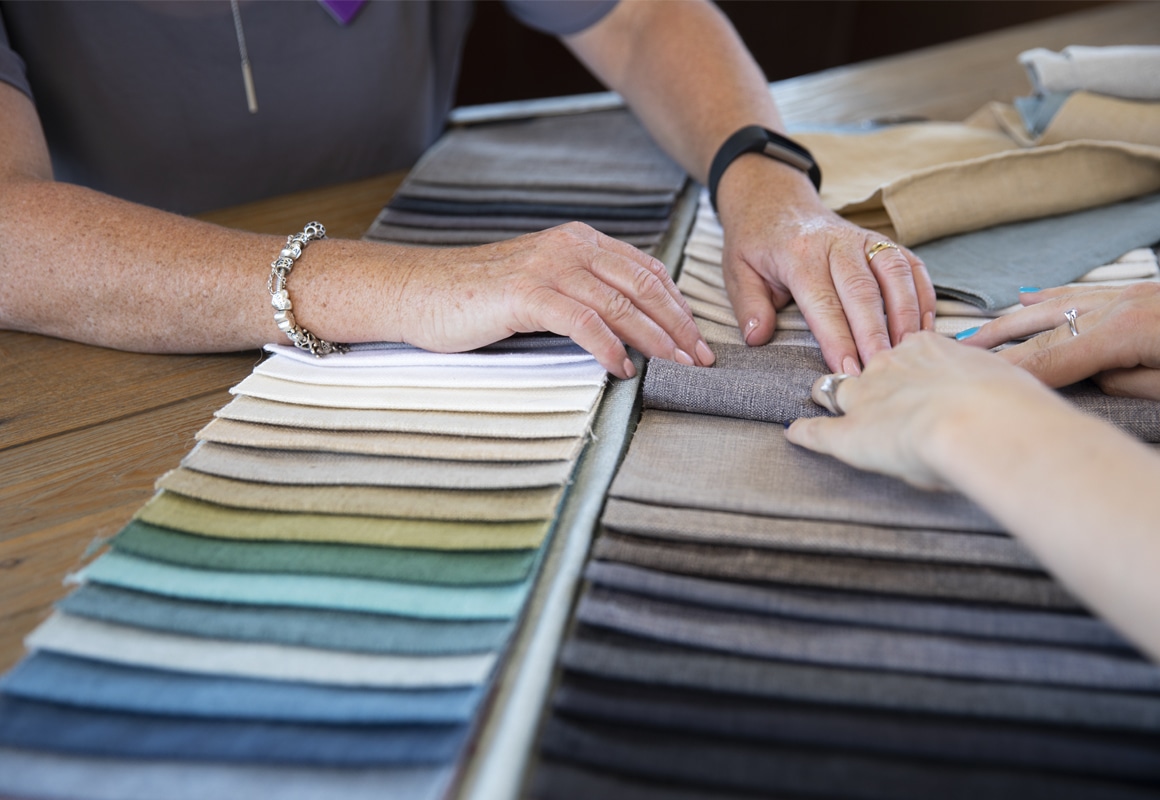 Russells consultant with customer and fabric sample 1160x800