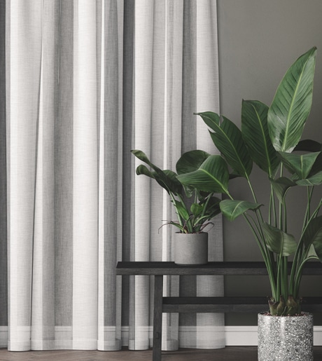 grey and white sheer curtains in calm modern room on grey walls