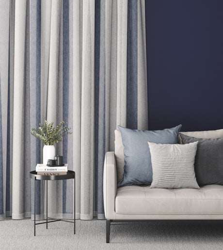 white grey and blue vertical stripe curtains in contemporary lounge room on navy blue walls
