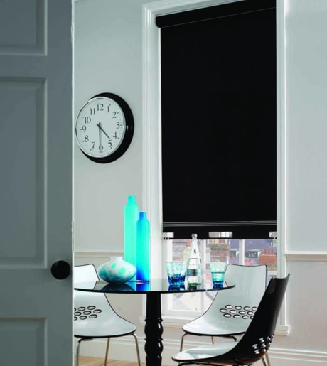 black blockout roller blind in contemporary dining room on white walls