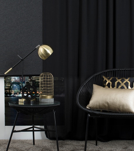 black roller blind and black curtains in moody contemporary lounge room