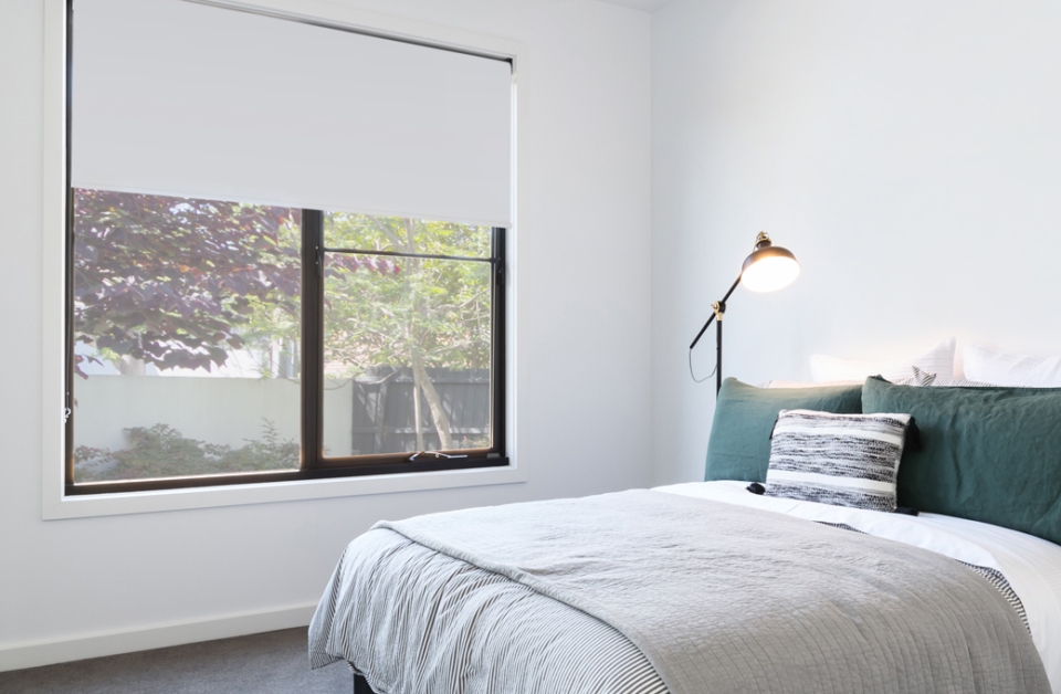 Bedroom with window and Russells blockout roller blinds